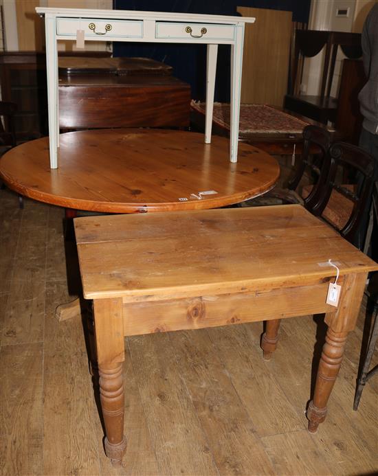 A circular pine kitchen table, W.138cms and a painted pine side table and another side table